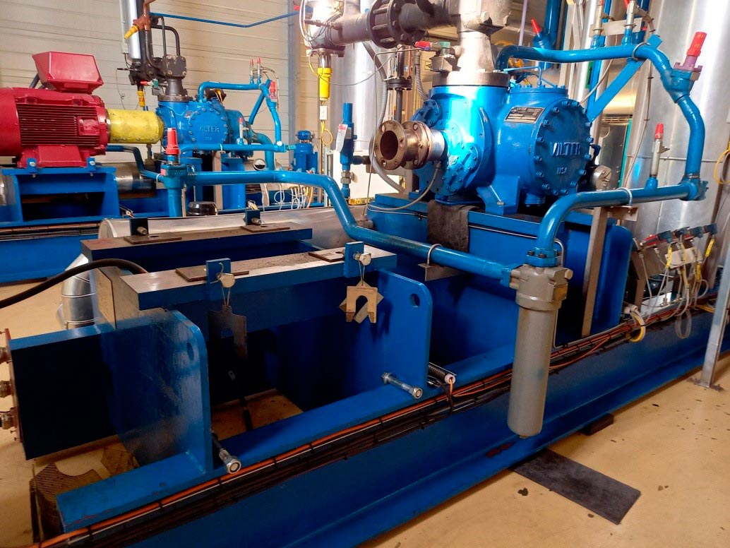Groupe motopompe industriel à moteur électrique, tuyauterie et filtration en atelier